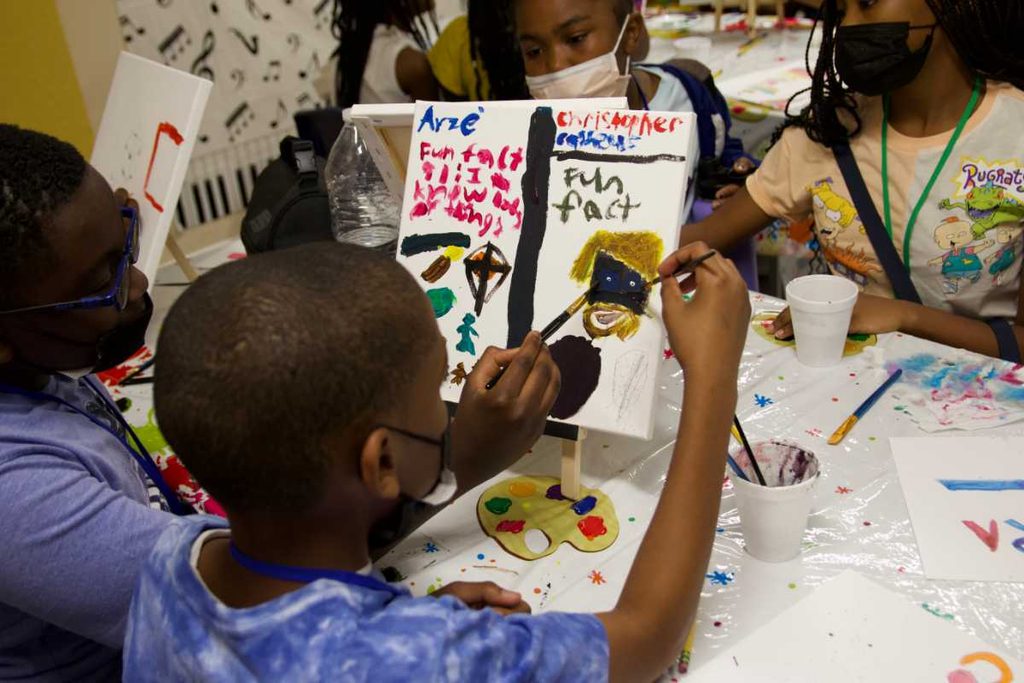 Campers create artwork during summer camp.
