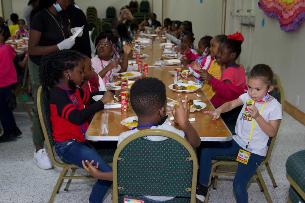 Campers share a meal during summer camp.